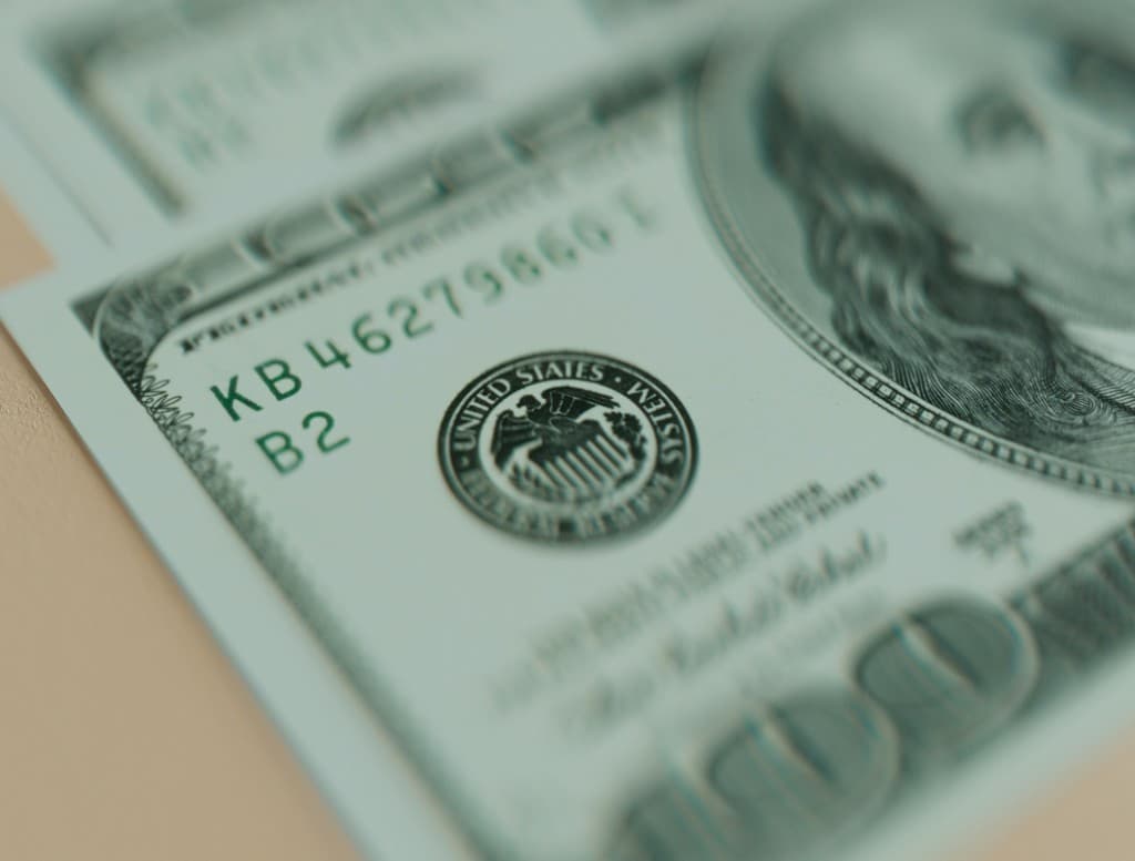 Close-up of US currency and financial details, representing SaaS revenue recognition, ASC 606, and audit readiness.